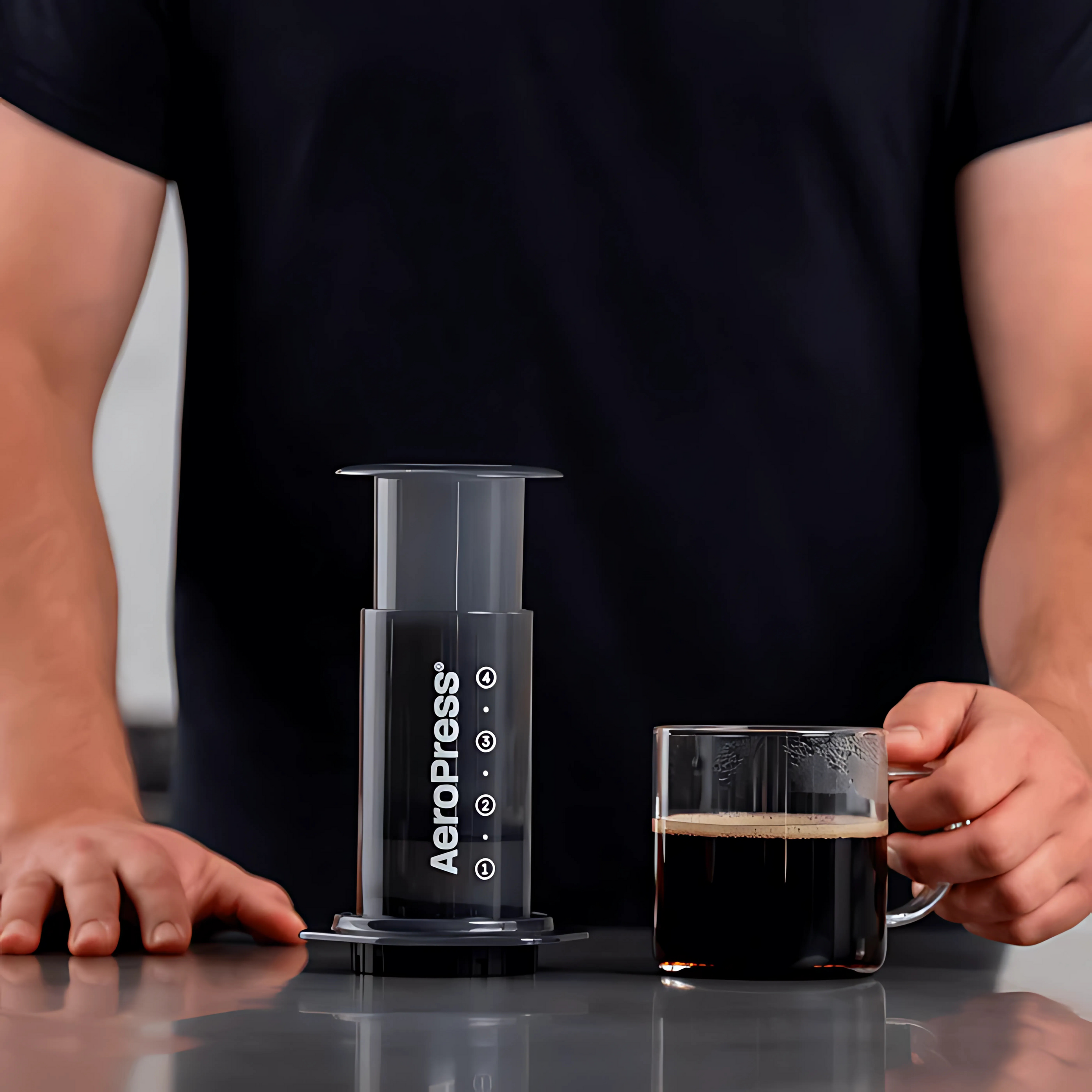 Man hanging on to coffee made with an AeroPress