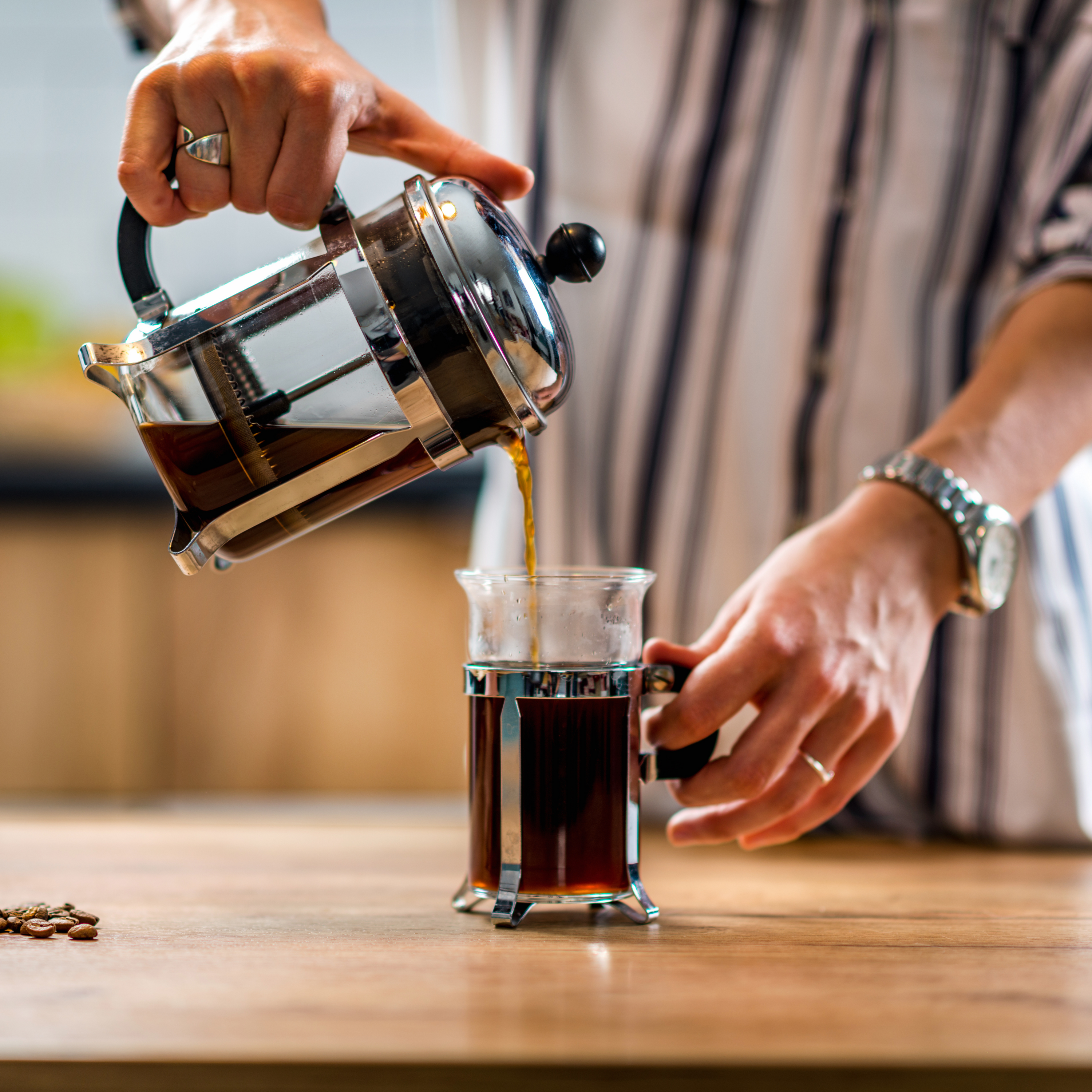 Person pouring coffee from a French Press