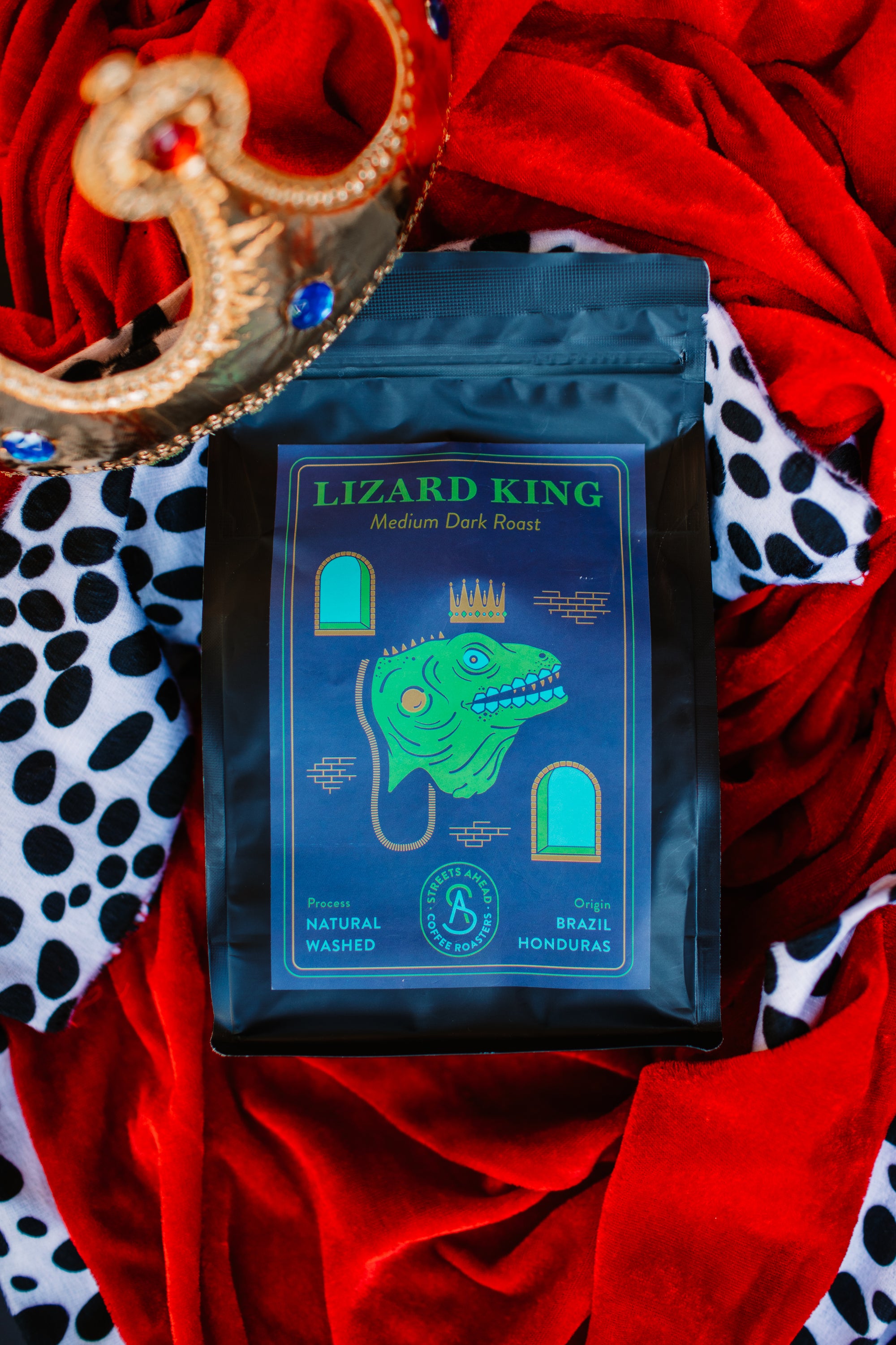 Coffee bag labeled 'Lizard King' on a colorful king's robe background