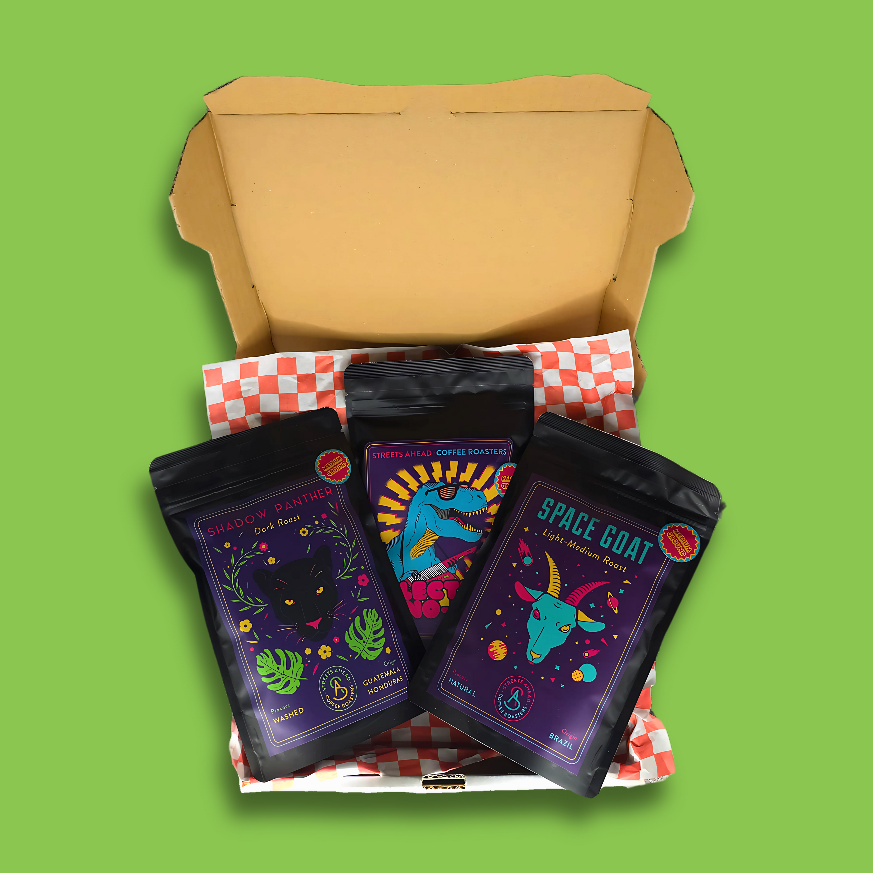 Pizza box filled with three 125g bags of Streets Ahead coffee.