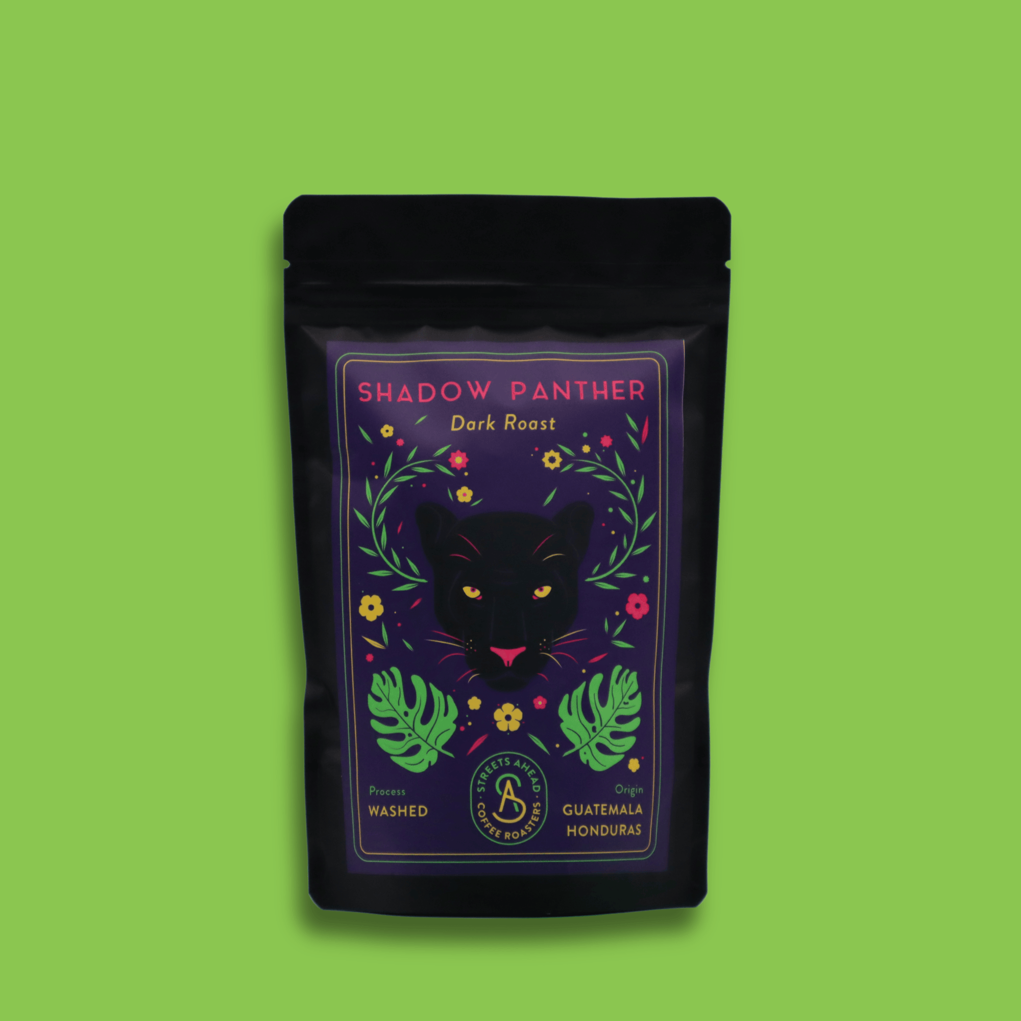 A 125g bag of dark roast, whole bean, Shadow Panther specialty coffee sitting in front of a green background.