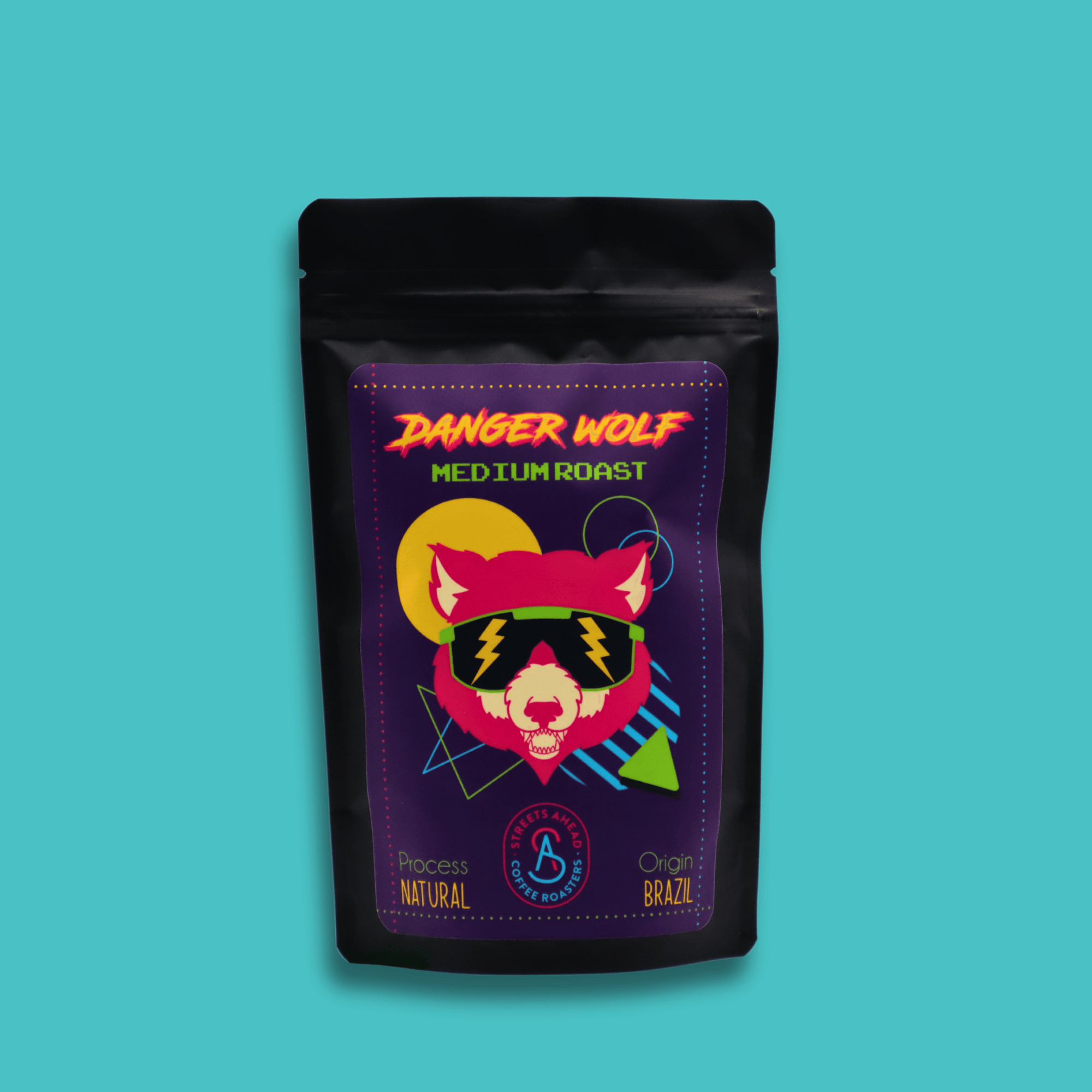 A 125g bag of medium roast, whole bean, Danger Wolf specialty coffee in front of a blue background.